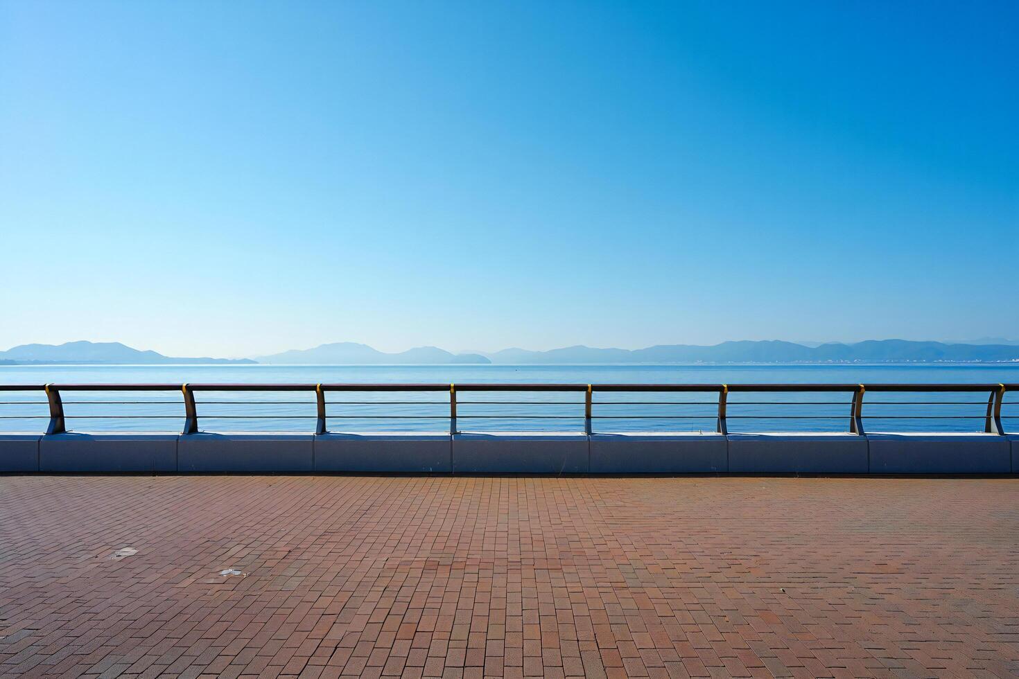 Beach Background Serene Seascape Brick Pathway Ocean View Metal Railing Calm Blue Sky photo