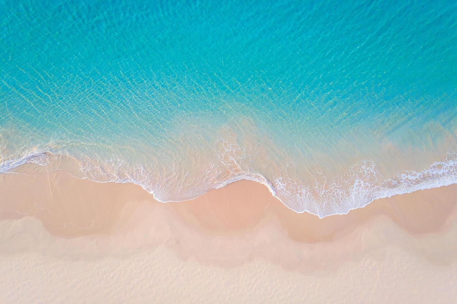 Beach Background Aerial View of Turquoise Ocean Waves Crashing on a Pristine Sandy Beach photo