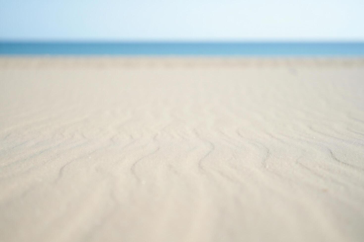 Beach Background Serene Beach Scene Soft Sand Texture with Blurred Ocean Background photo