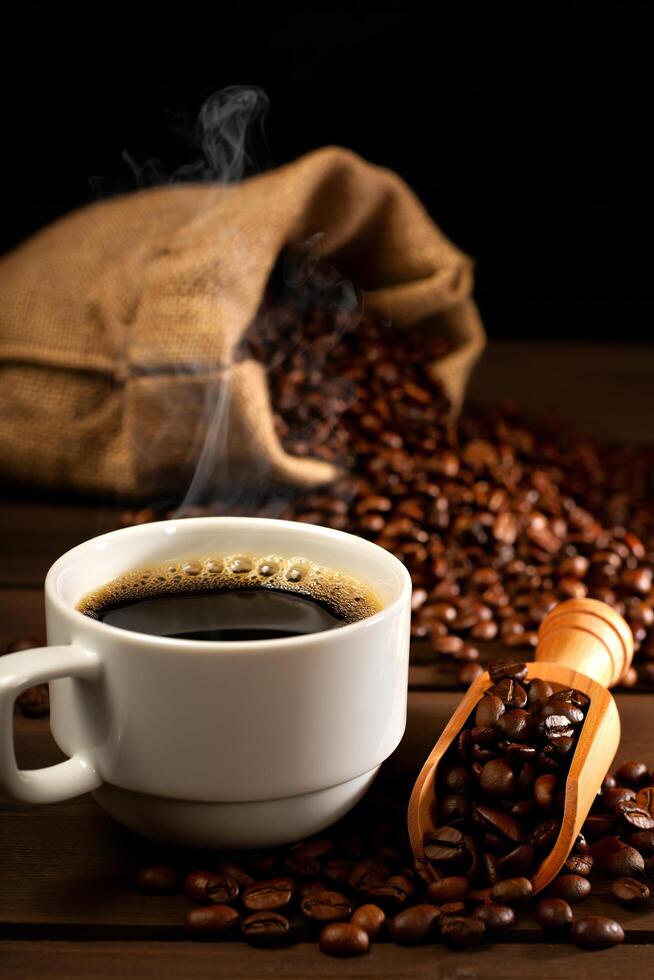 Coffee Background Aromatic Coffee Cup with Steaming Brew and Roasted Beans in Burlap Sack photo