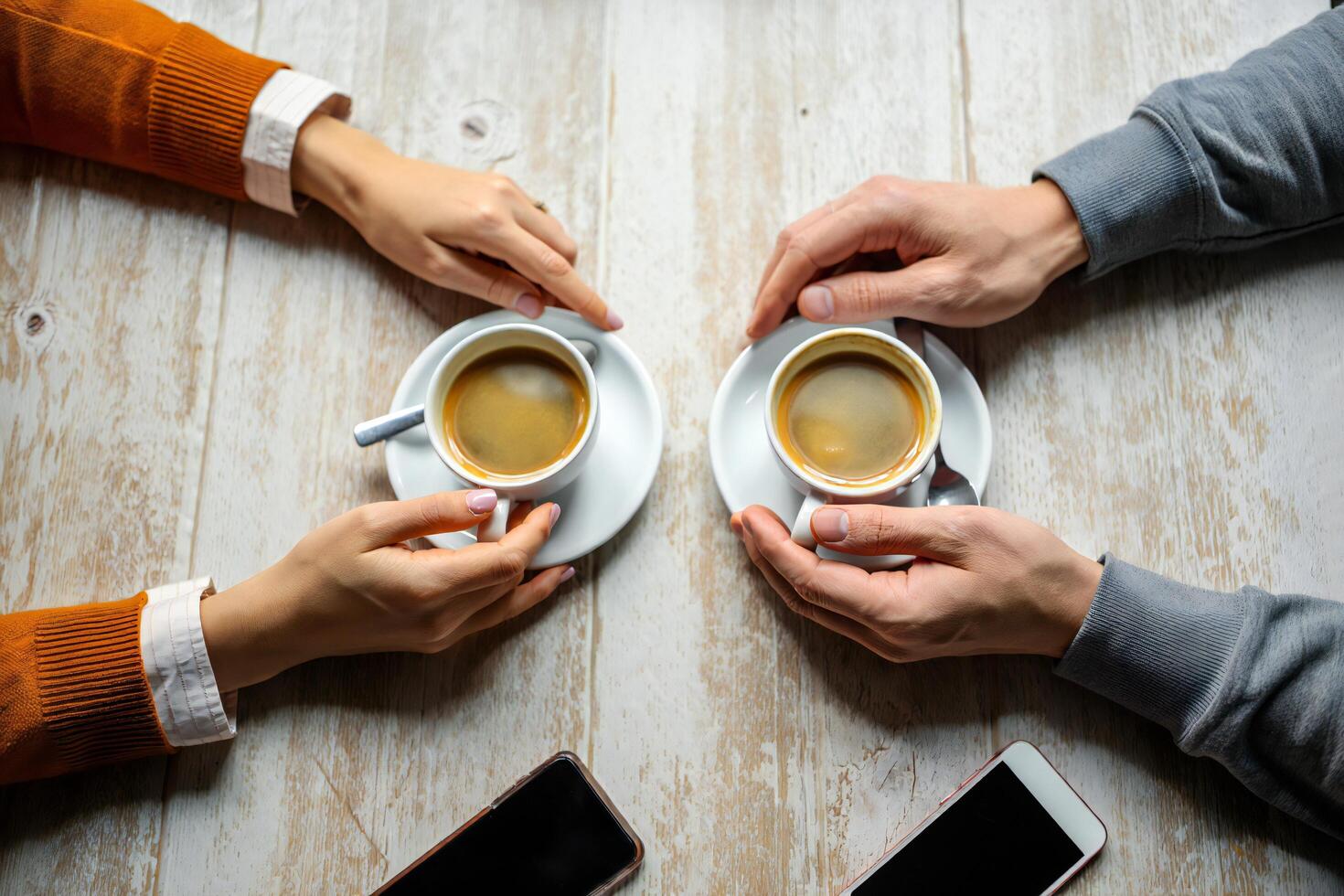 Coffee Background Couple Enjoying Coffee Together at a Cafe Top View Hands Holding Cups photo