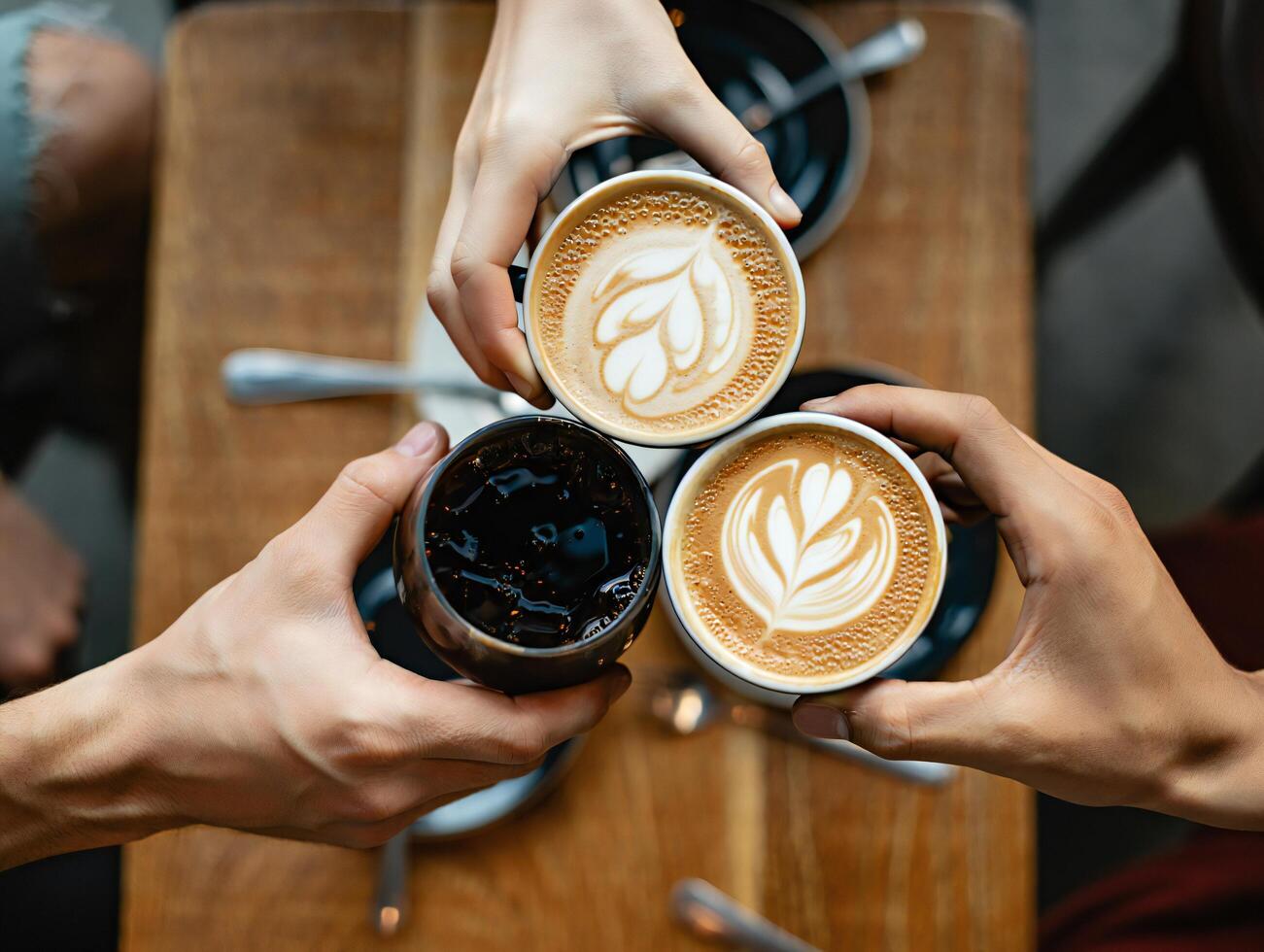 Coffee Background Three Hands Toasting with Coffee Drinks Latte Art Cafe Scene photo