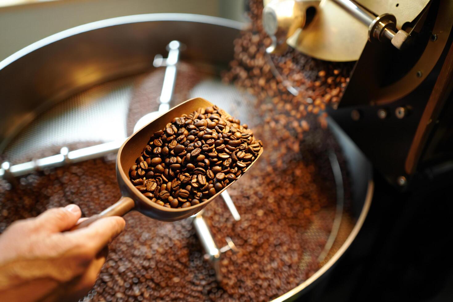 Coffee Background Roasted Coffee Beans Being Scooped from Industrial Coffee Roaster Machine photo