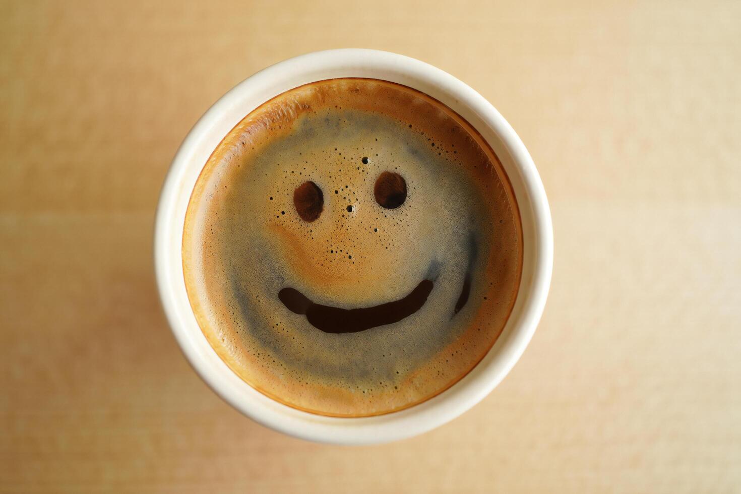 Coffee Background Happy Coffee Face Smiling Espresso in Disposable Cup on Wooden Table photo
