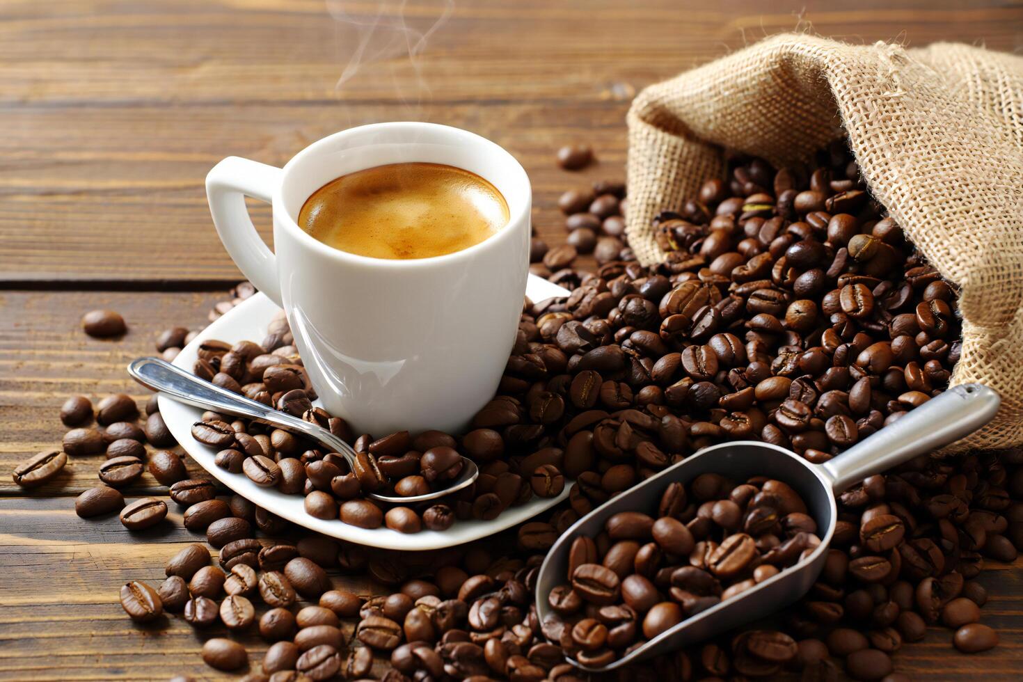 Coffee Background Aromatic Espresso Coffee in White Cup Surrounded by Roasted Beans photo