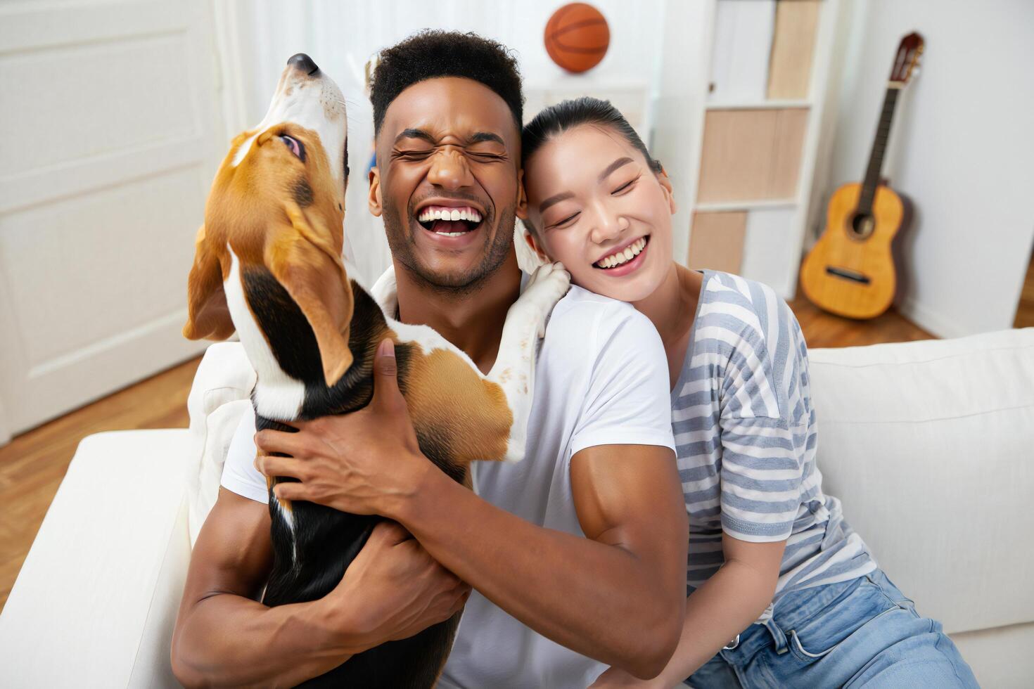 Dog Background Happy Interracial Couple Cuddling Beagle Dog at Home Smiling and Laughing photo