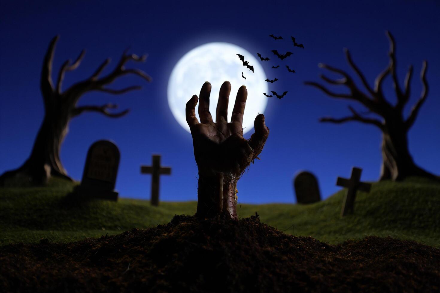 Halloween Background Spooky Halloween Graveyard Scene Zombie Hand Emerging from Grave at Night photo