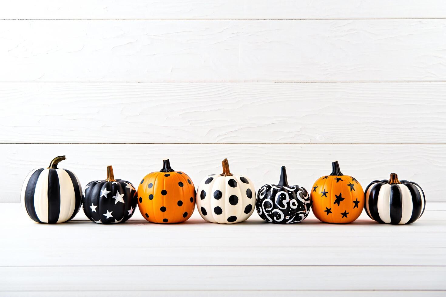 Halloween Background Halloween Decor Six Stylish Pumpkins with Black White and Orange Designs on White Wood photo