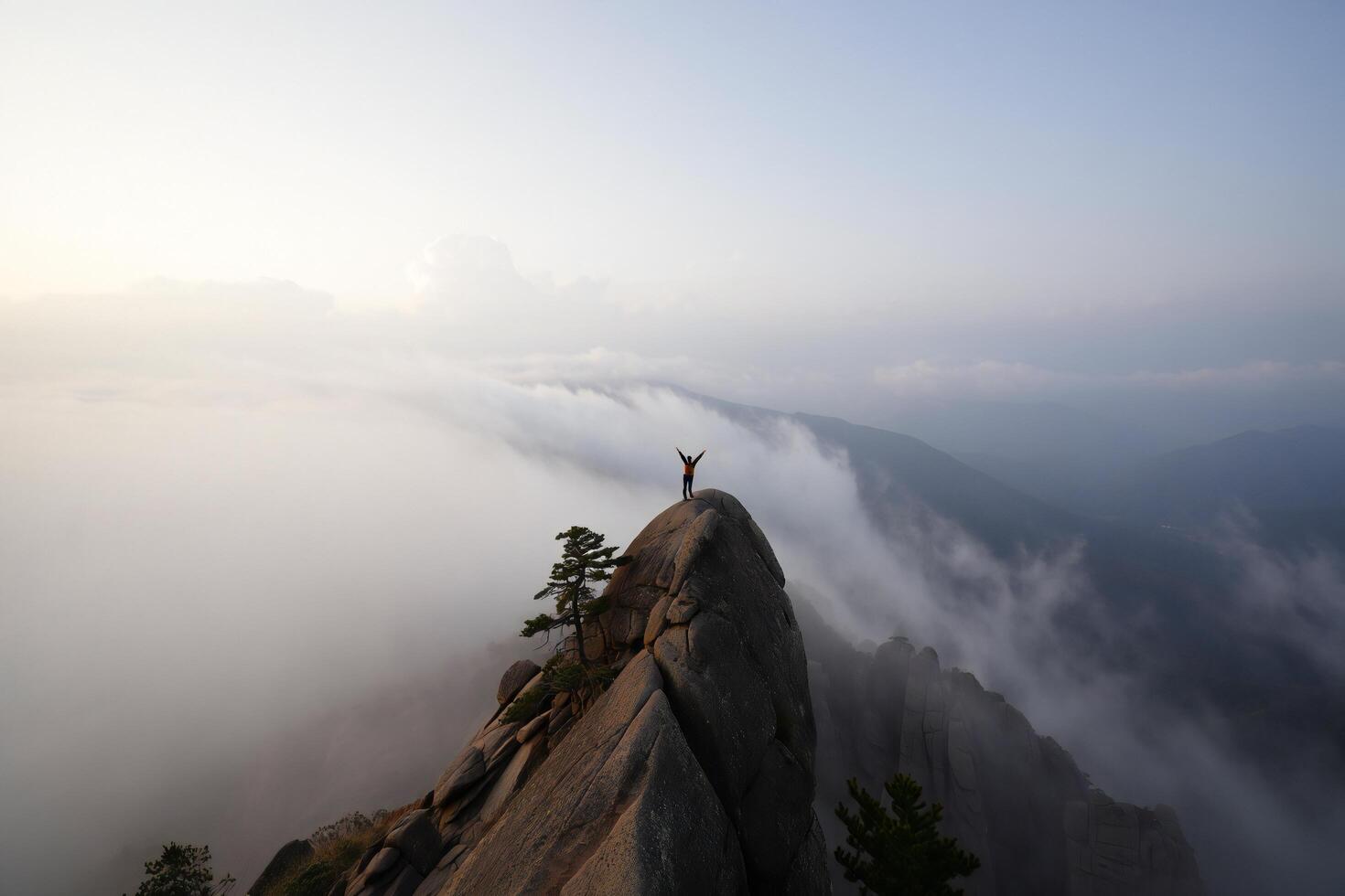 Nature Background Adventurous Hiker Triumphantly Standing on Mountain Peak Above Cloudscape photo
