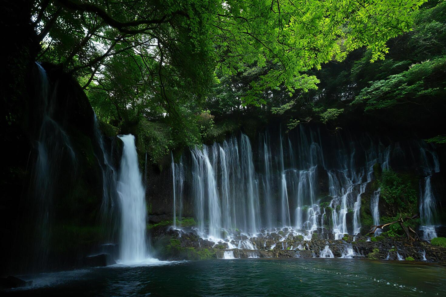 Nature Background Serene Waterfall Cascading Down Mossy Cliff Face in Lush Green Forest photo