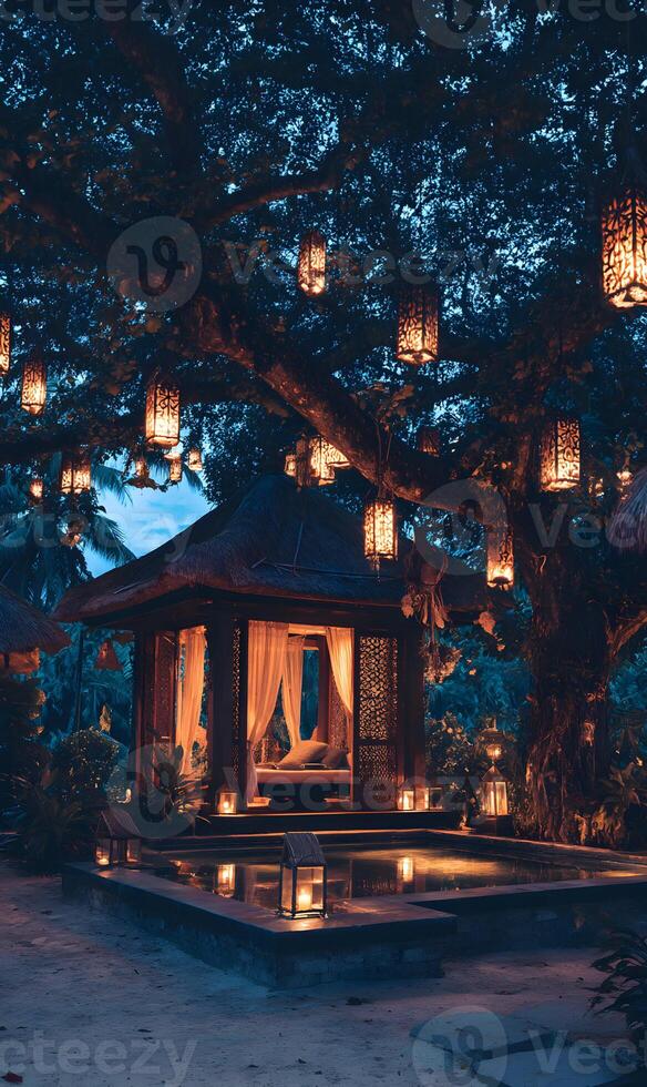 Serene evening retreat illuminated lanterns under a majestic tree canopy creating a magical ambiance photo