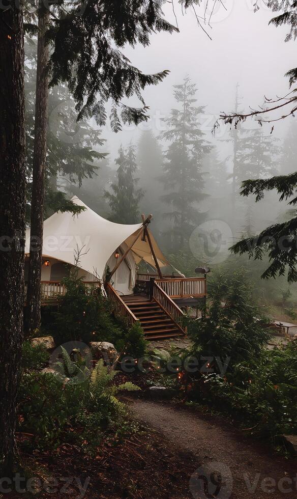 Scenic forest retreat beckons with a tent structure blending harmoniously amidst the foggy trees serene outdoor setting photo