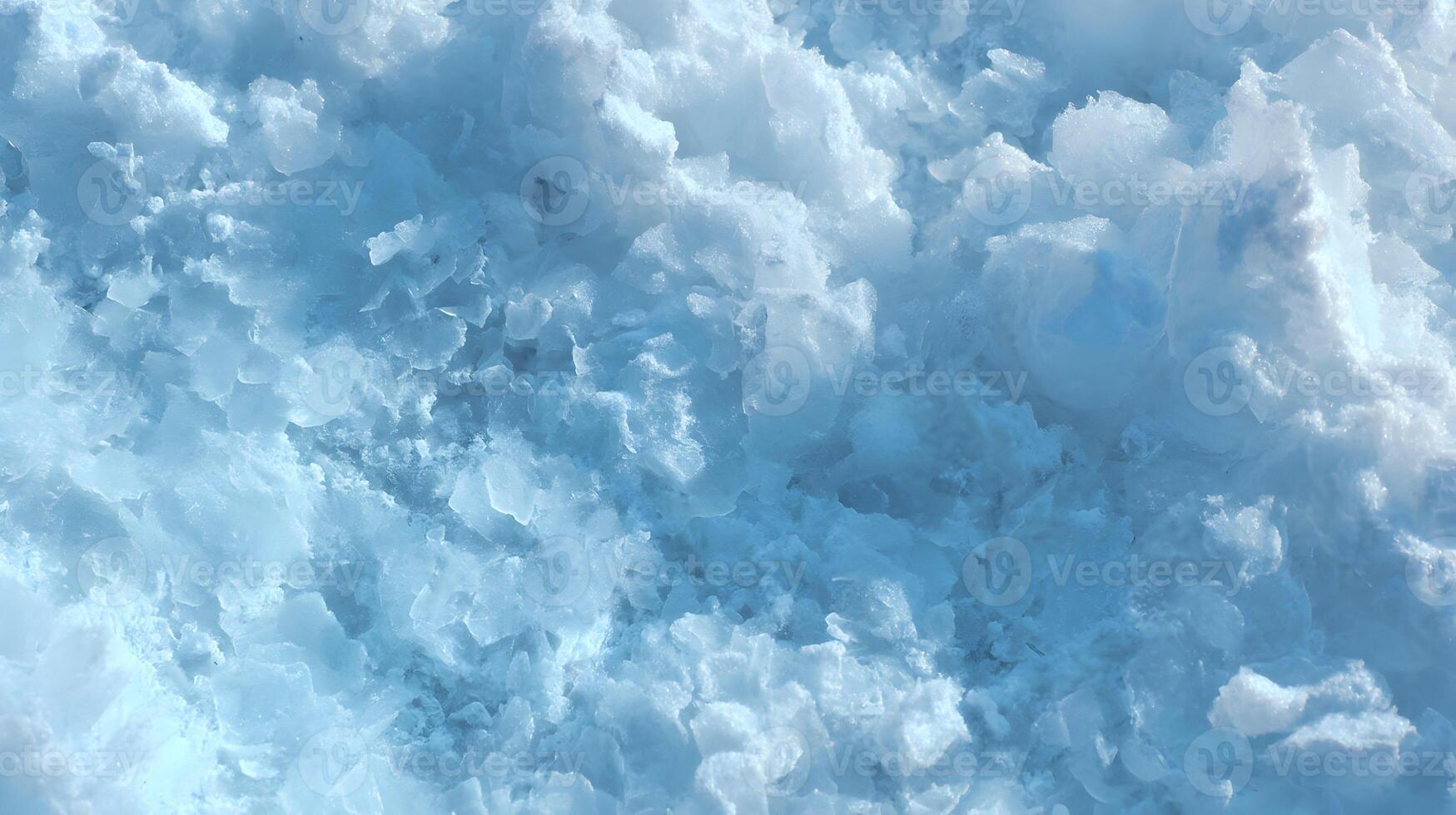 Abstract close up of fresh snow texture with blue tones reveals an icy crystal landscape photo