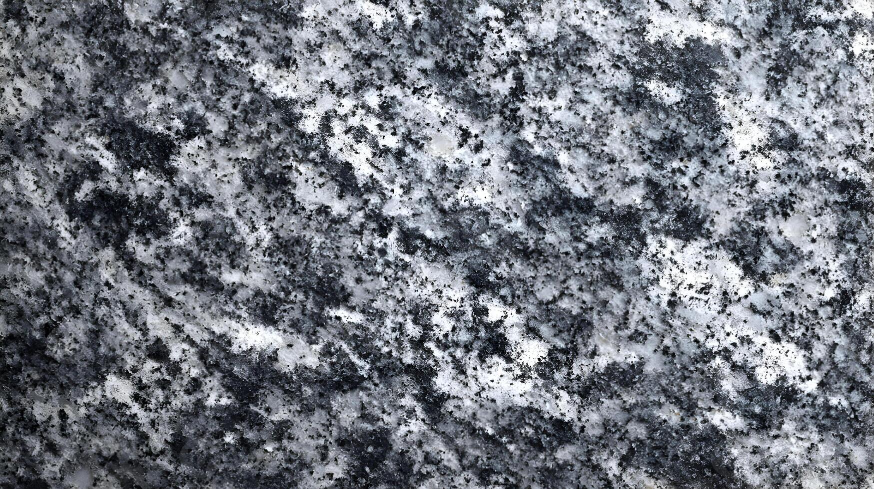 Detailed and textured granite surface shows a beautiful blend of black grey and white colors, creating a unique pattern photo
