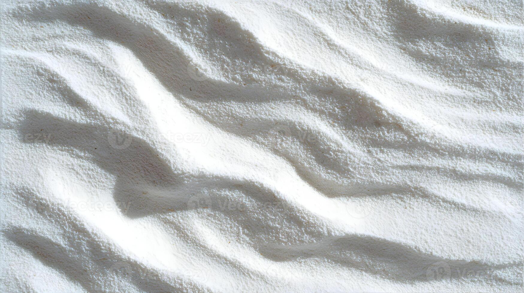 A pristine landscape of white sand dunes casting soft shadows in the bright sunlight creating an abstract pattern photo