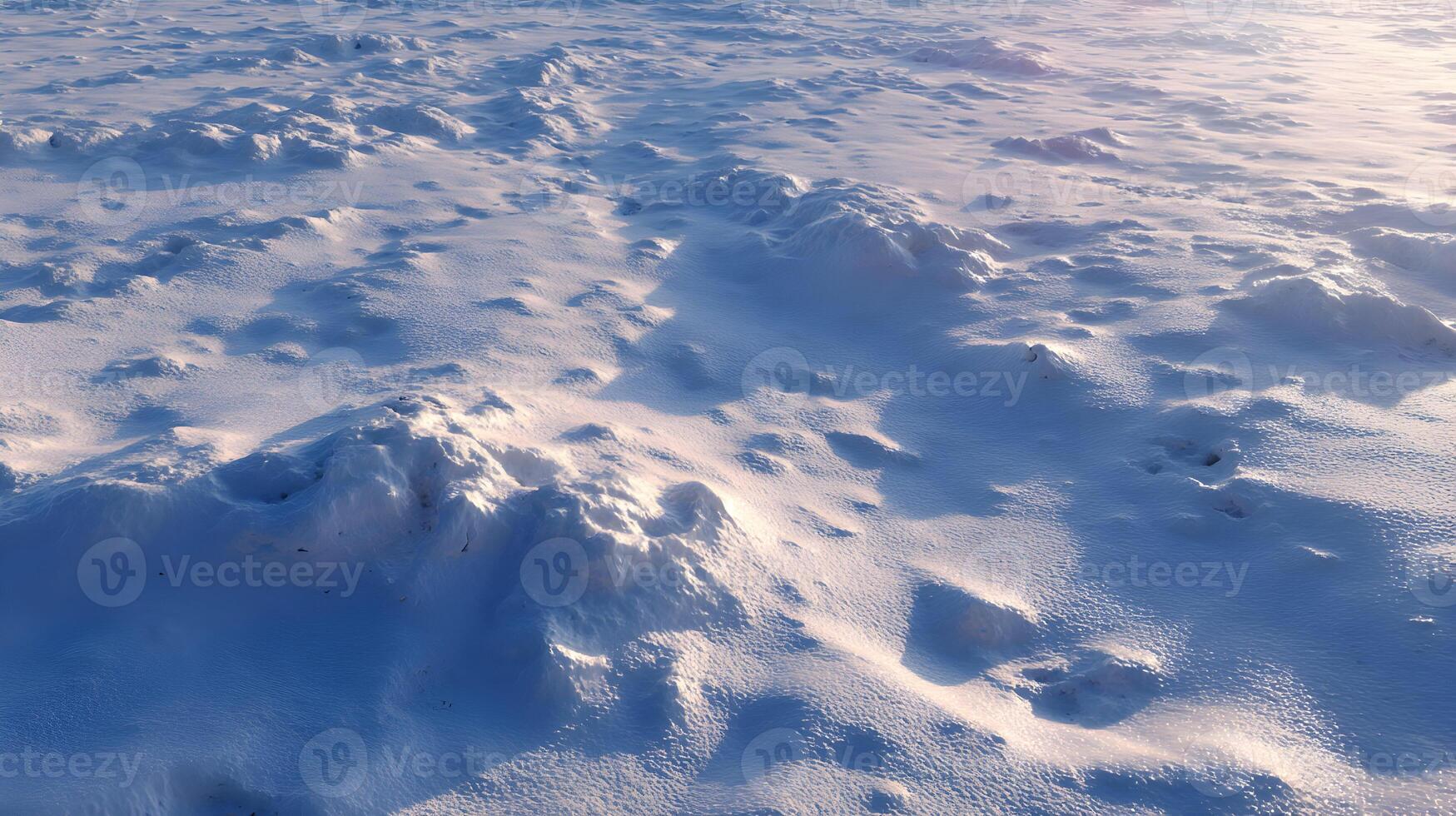 Snow covered ground texture creates an abstract winter landscape bathed in soft sunlight showcasing natural beauty photo