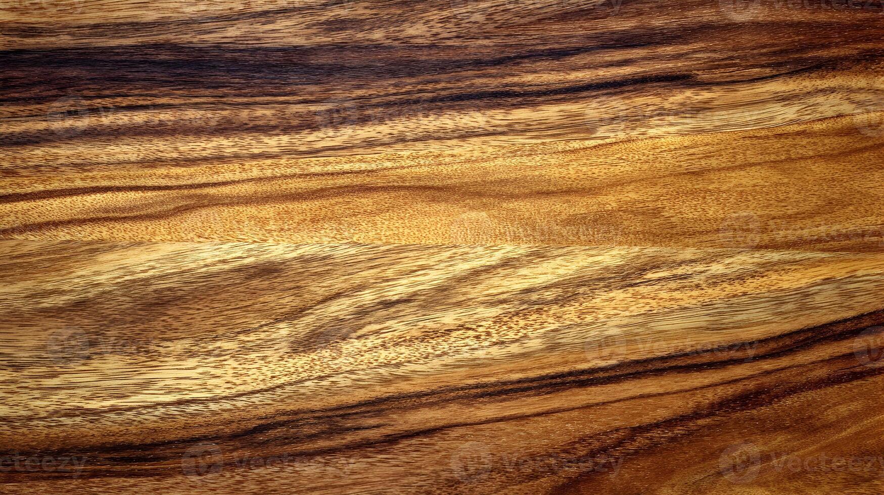 Detailed close up of a textured wood surface showcasing natural patterns and warm, rich colors creating a rustic aesthetic photo