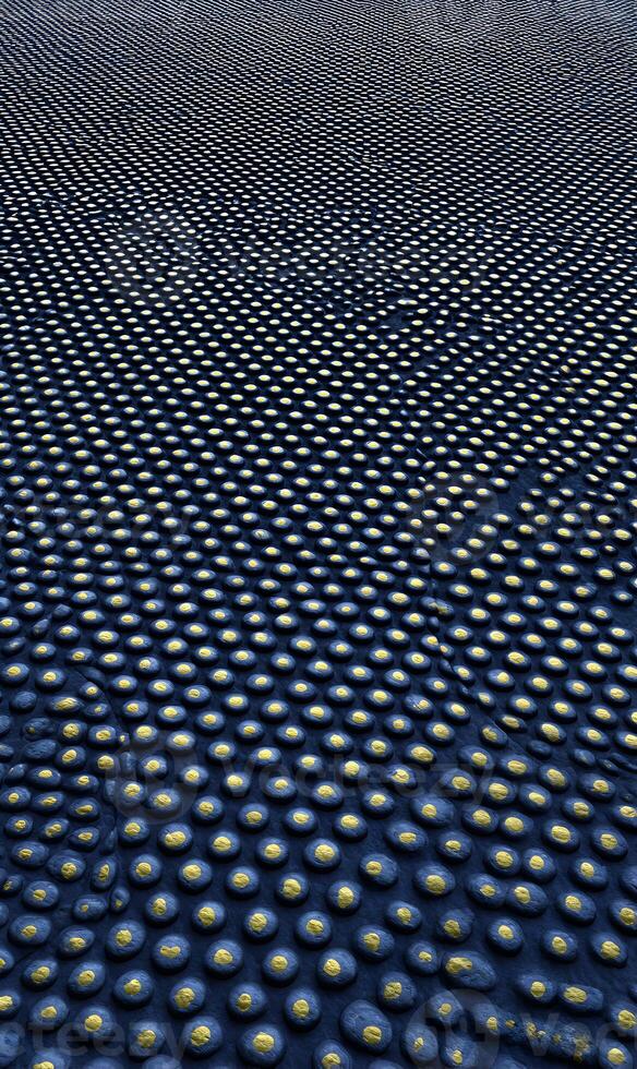 Abstract dark field with evenly spaced bright dots creating a rhythmic pattern and a sense of depth and vastness photo