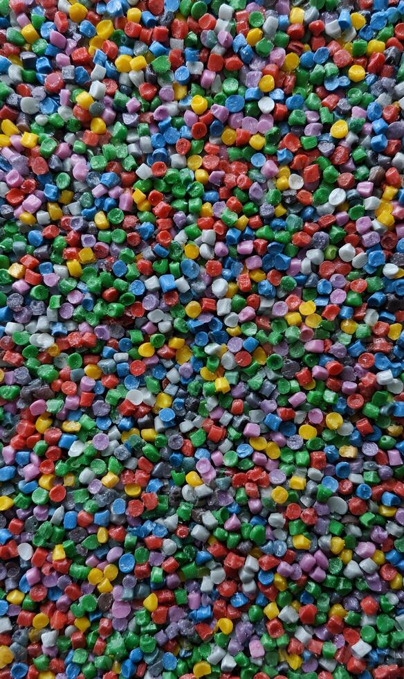Vibrant assortment of colorful plastic granules creates a lively and visually stimulating background texture perfect for creative designs photo