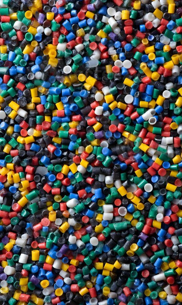 Vibrant multicolored plastic pellets providing a stunning texture for industrial application or design element showcasing the versatility of plastic materials photo