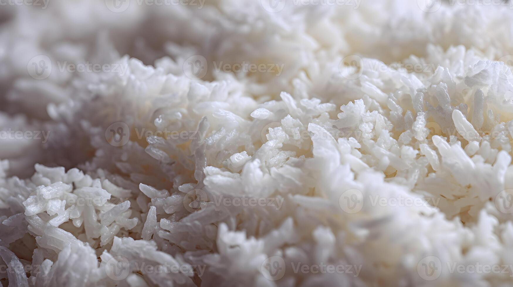 Close up of fluffy and freshly cooked white rice grains creating a textured background pattern photo