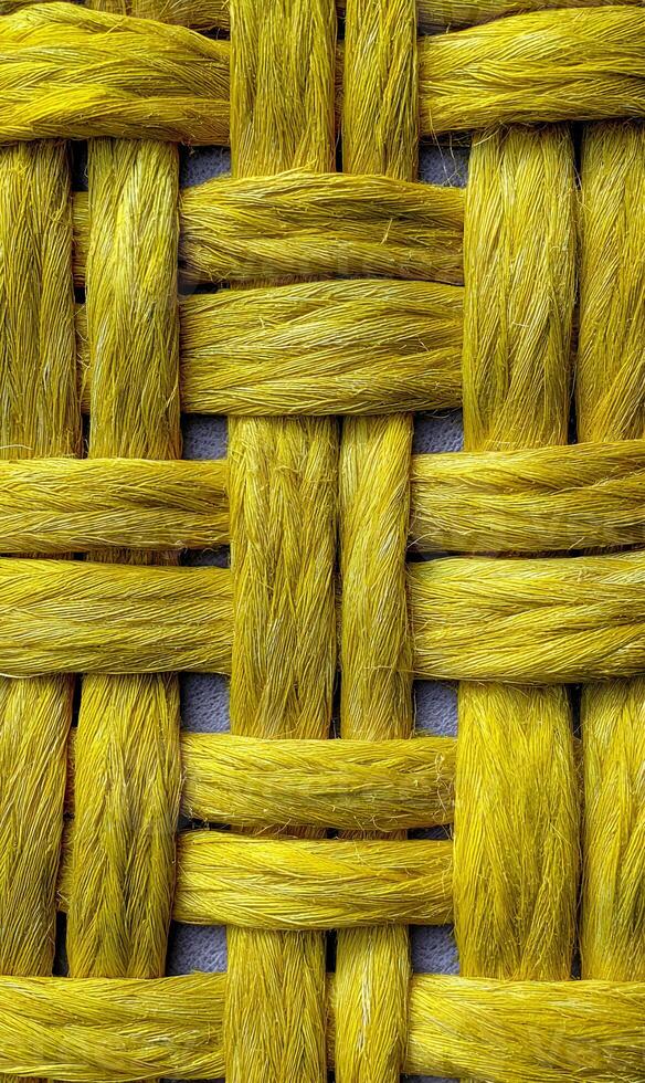 Intricate weaving creates a captivating textured pattern featuring yellow strands a visually stunning design of craftsmanship photo