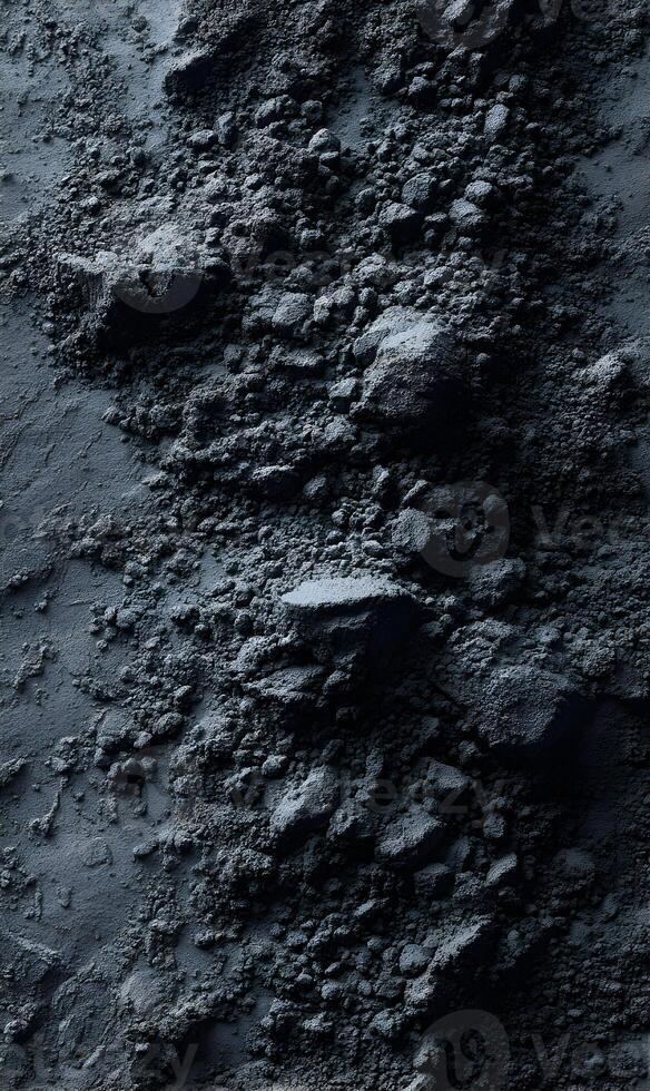 Textured surface of dark volcanic rock and ash creates a desolate and lunar landscape environment photo