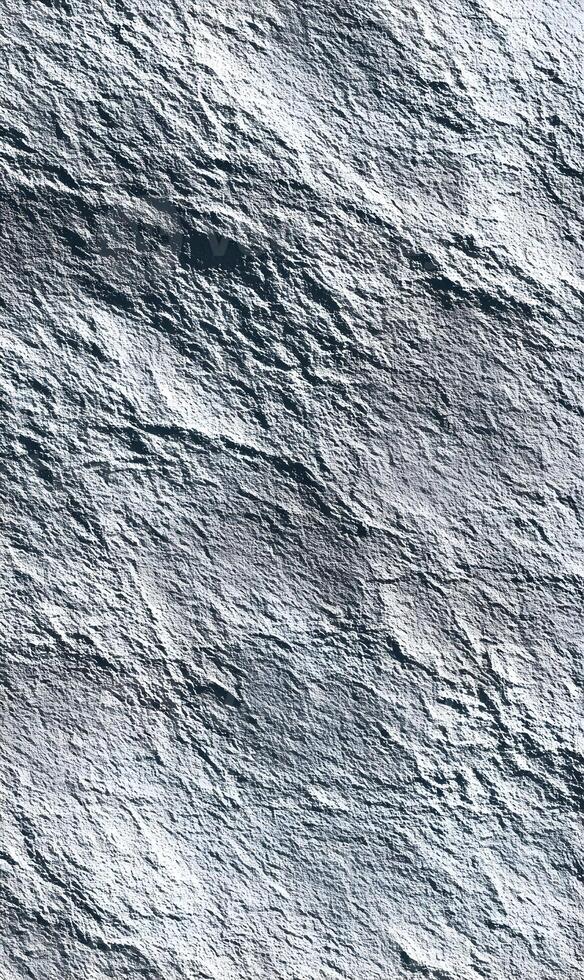 Elevated view of a rugged rock surface creating a unique abstract pattern and texture for designs and backgrounds with natural gray tones photo