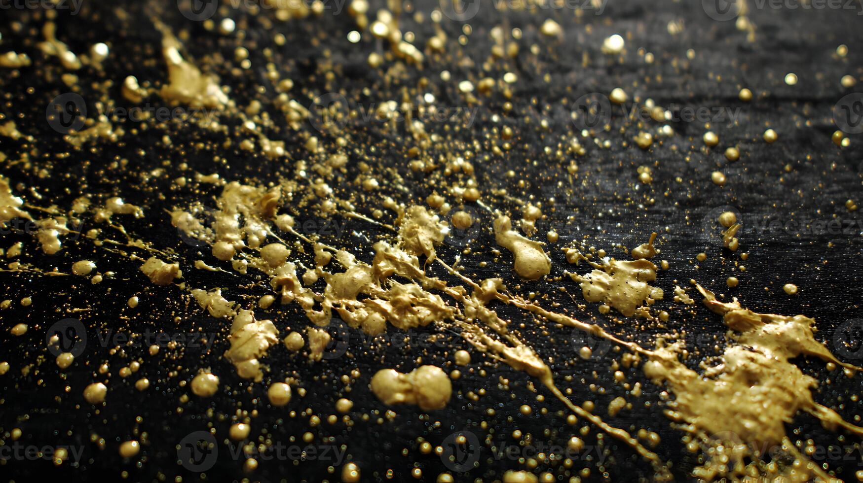 Luxurious gold paint splatters on a textured dark surface adding a touch of elegance and sophistication photo