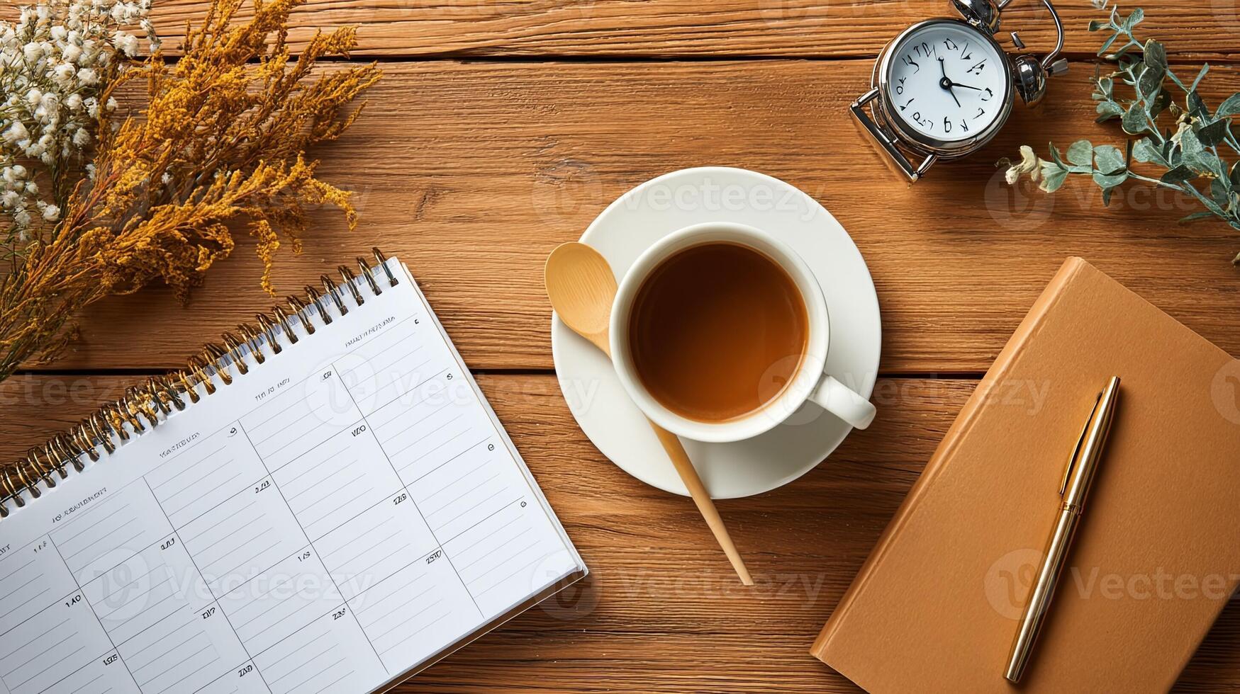 Cozy Workspace with Tea, Clock, and Notebook on Wooden Desk photo