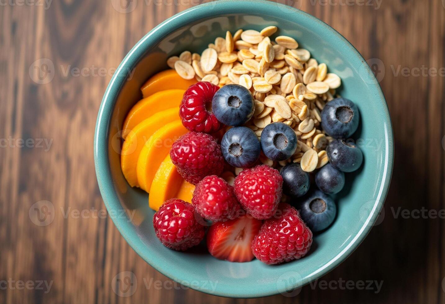 A bowl of fruit and oats on a wooden table photo