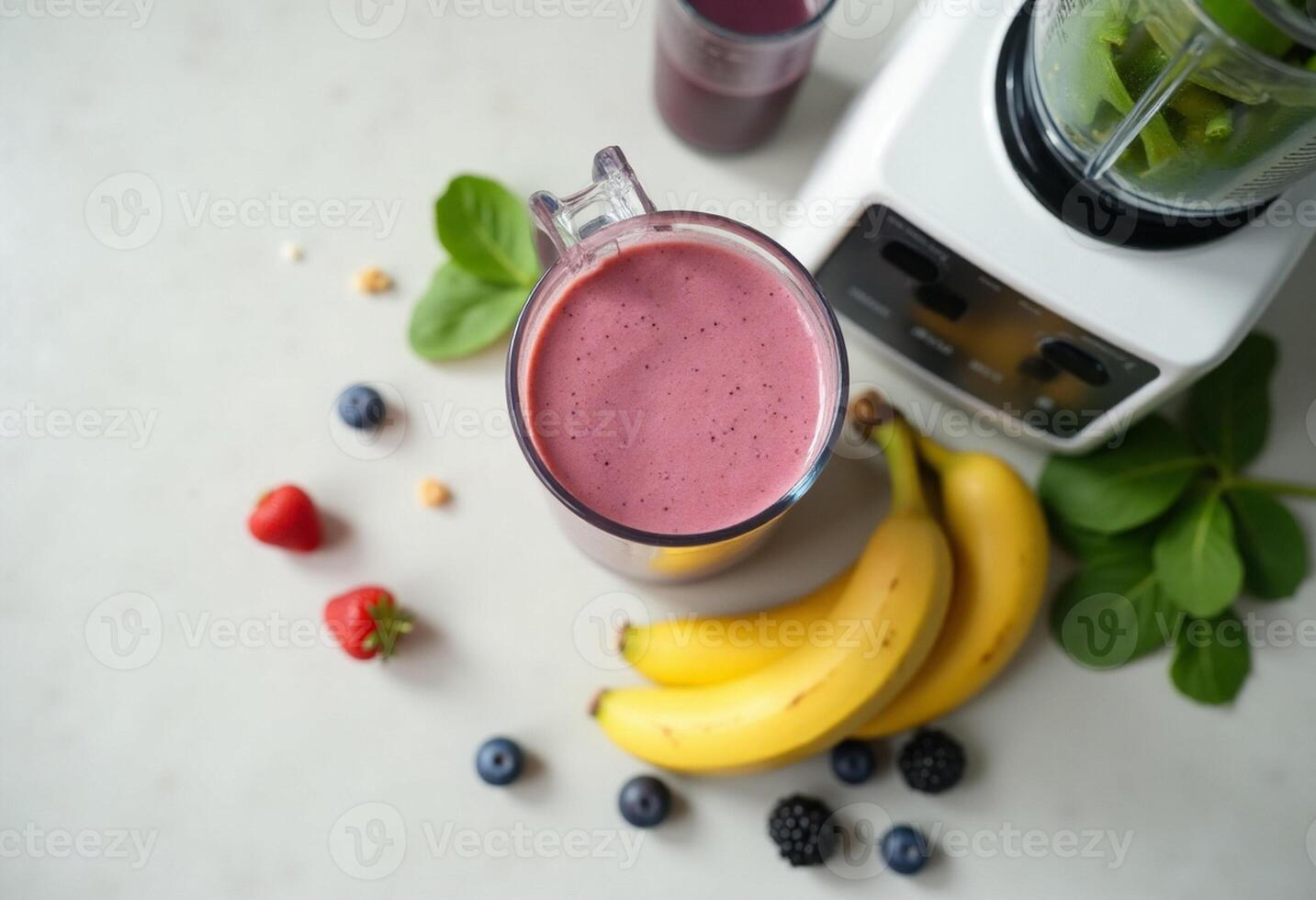 A blender with a smoothie and bananas photo