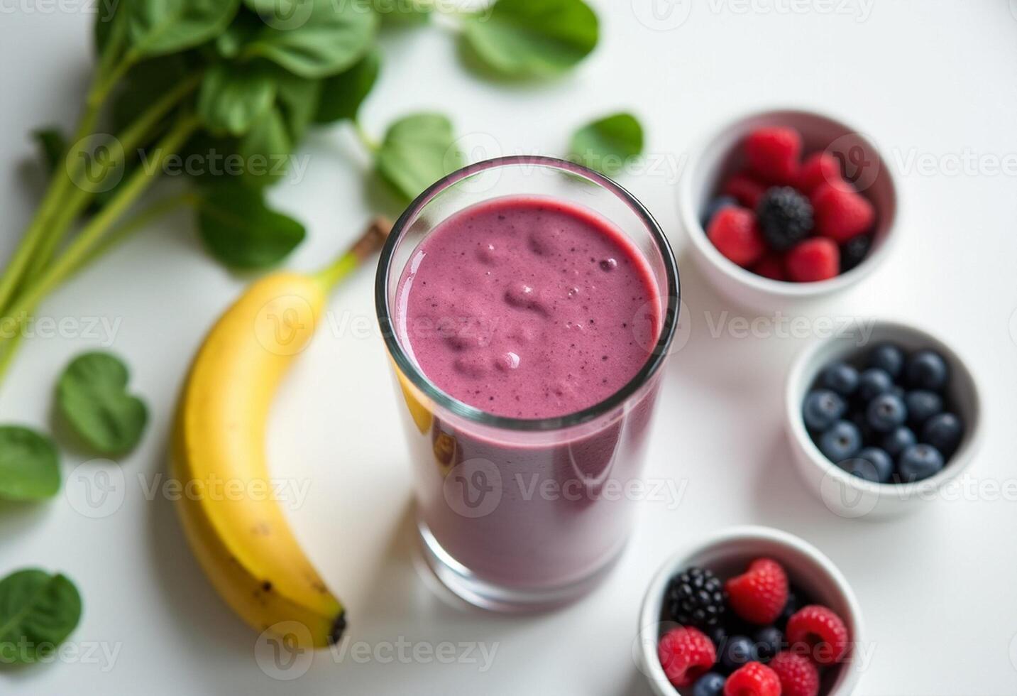 A glass of smoothie with berries and bananas photo