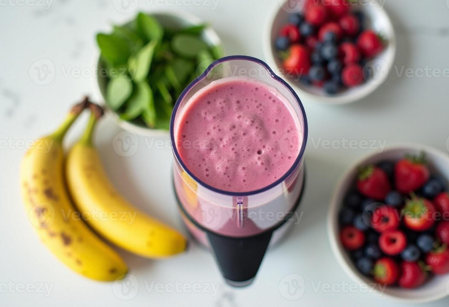 A blender with a smoothie in it and some fruit photo