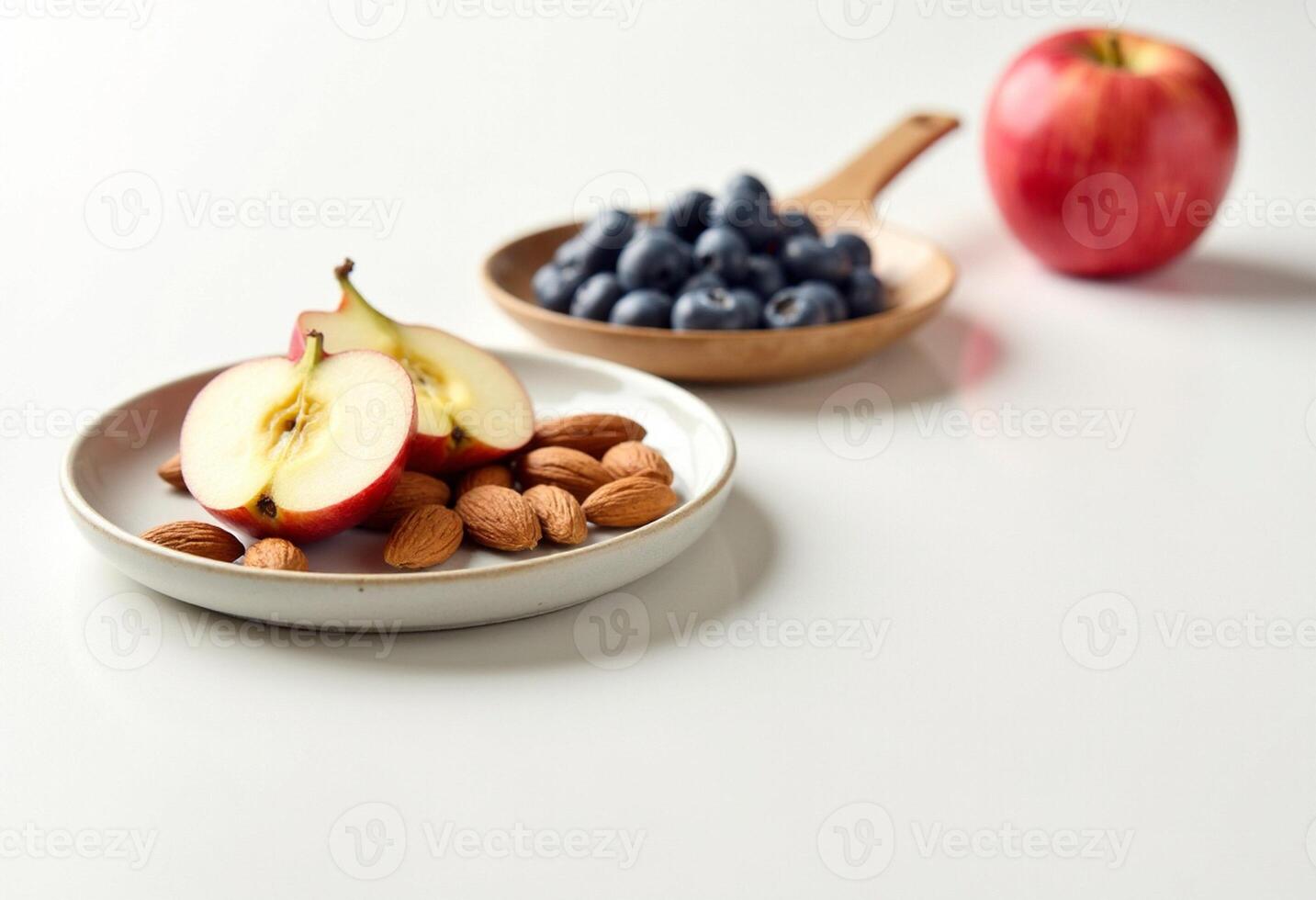 Blueberries, almonds and apples on white background photo