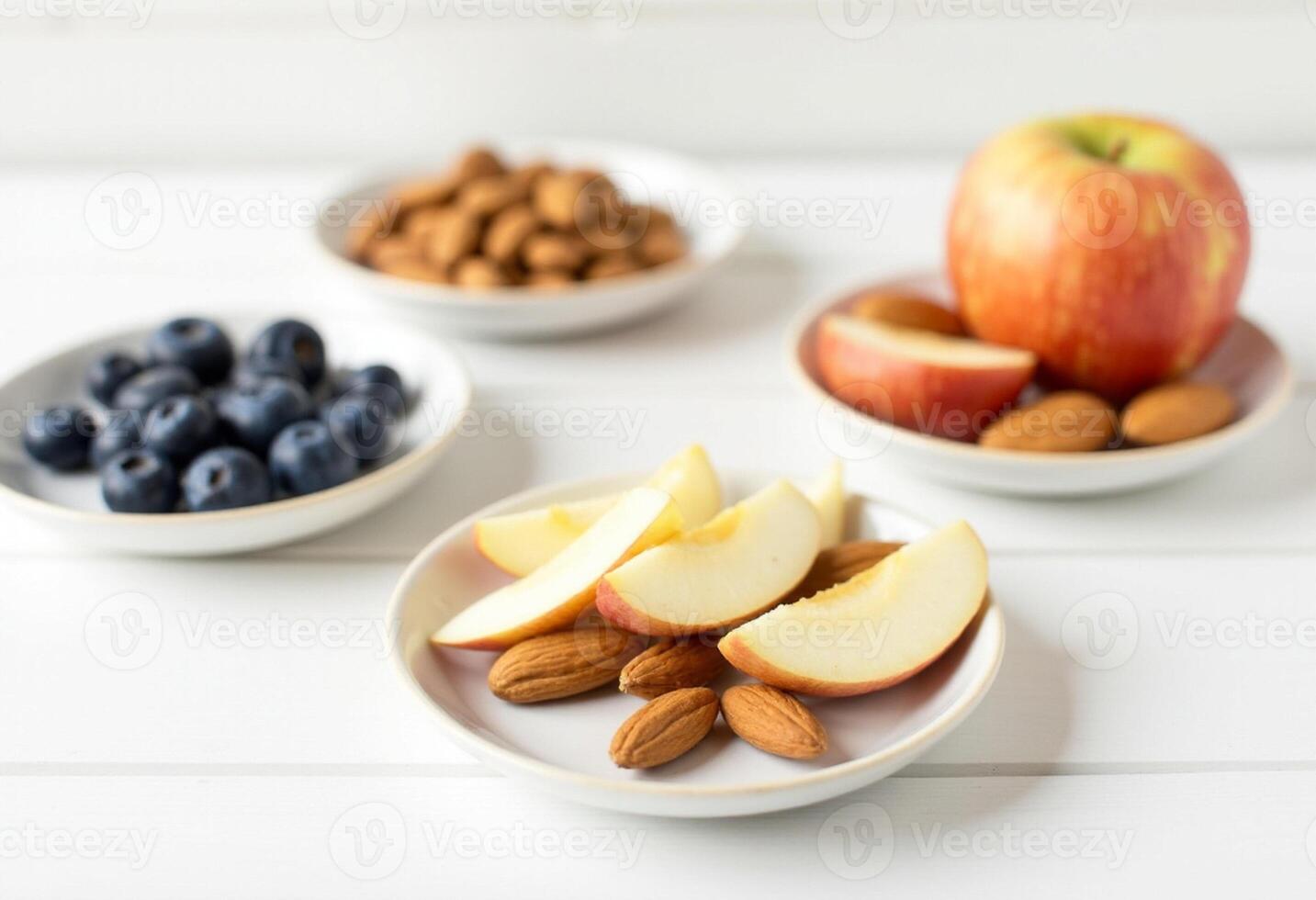 Three bowls with apples, almonds and blueberries photo