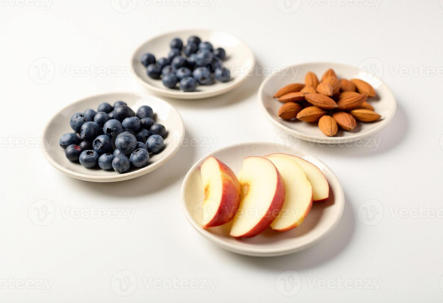 Three bowls with blueberries, almonds and apples photo