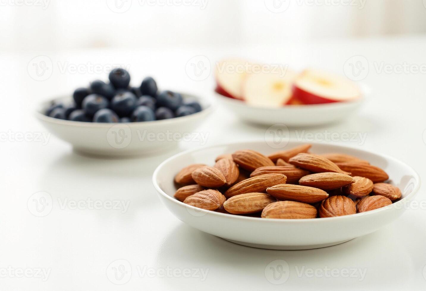Two bowls of almonds and blueberries photo