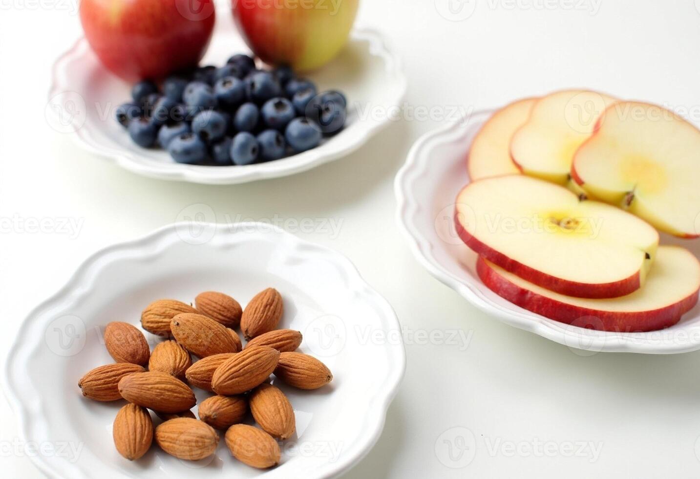 A bowl of apples, blueberries, and almonds photo
