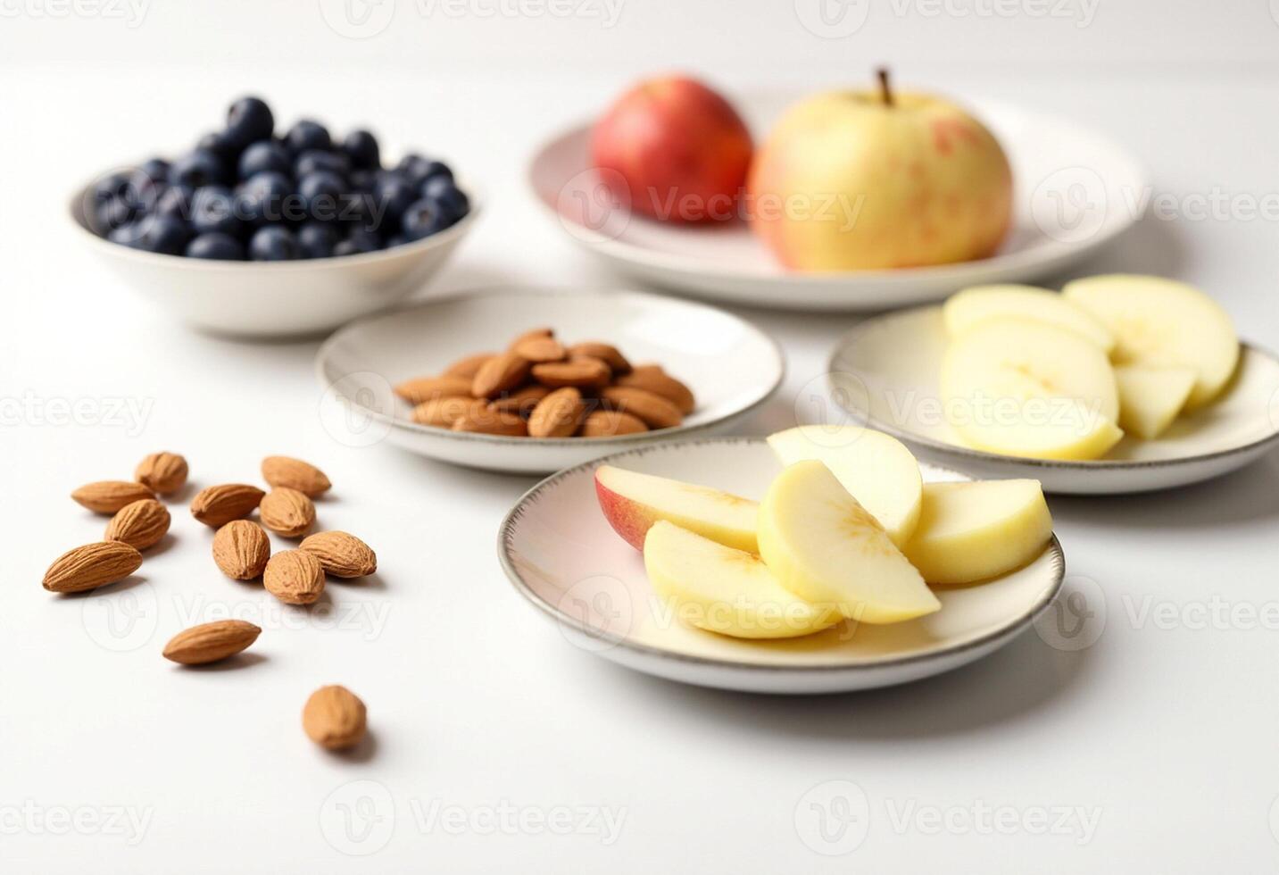 A bowl of apples, blueberries, almonds and an apple photo