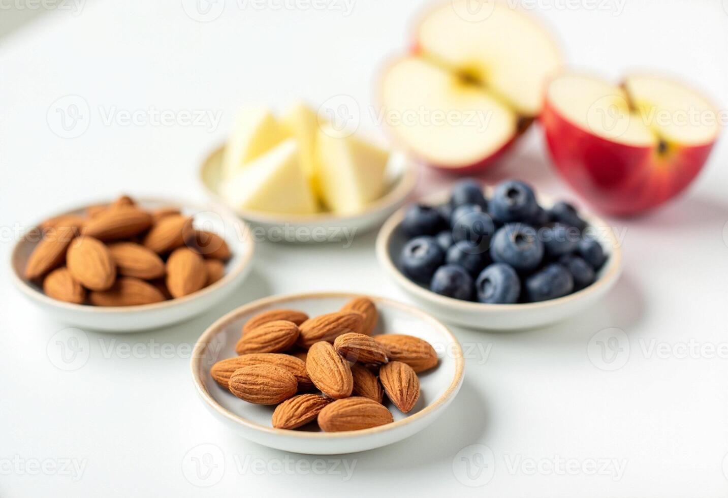 Three bowls of almonds, blueberries, and apples photo