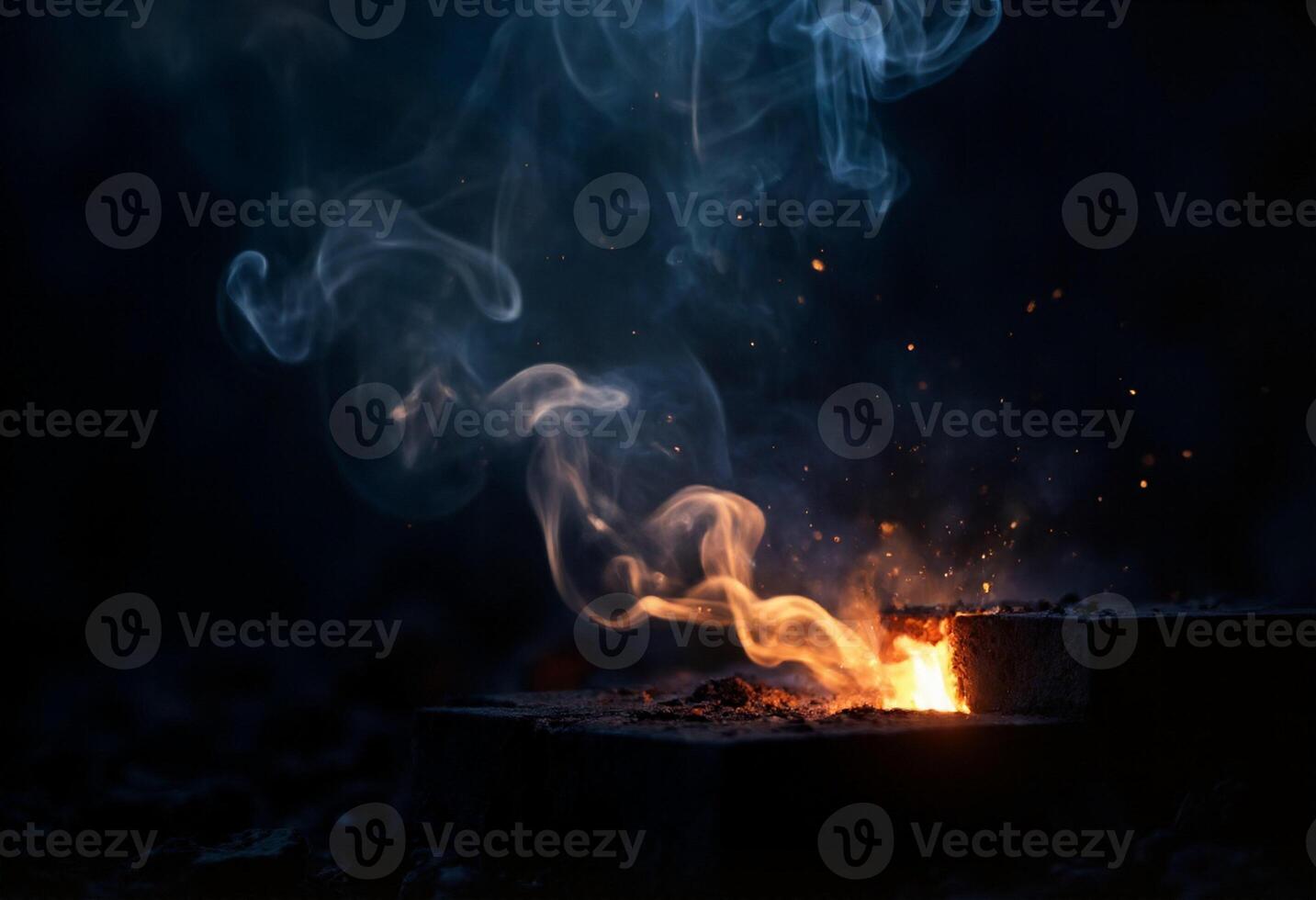 A fire is burning on a brick with smoke coming out photo
