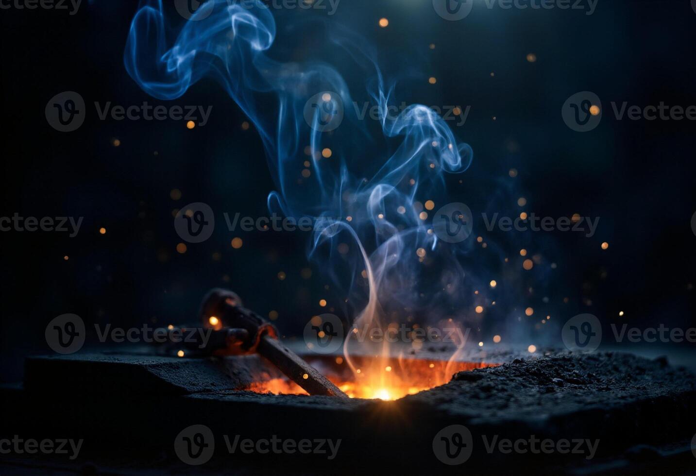 A blacksmith is working on a piece of metal with a torch photo