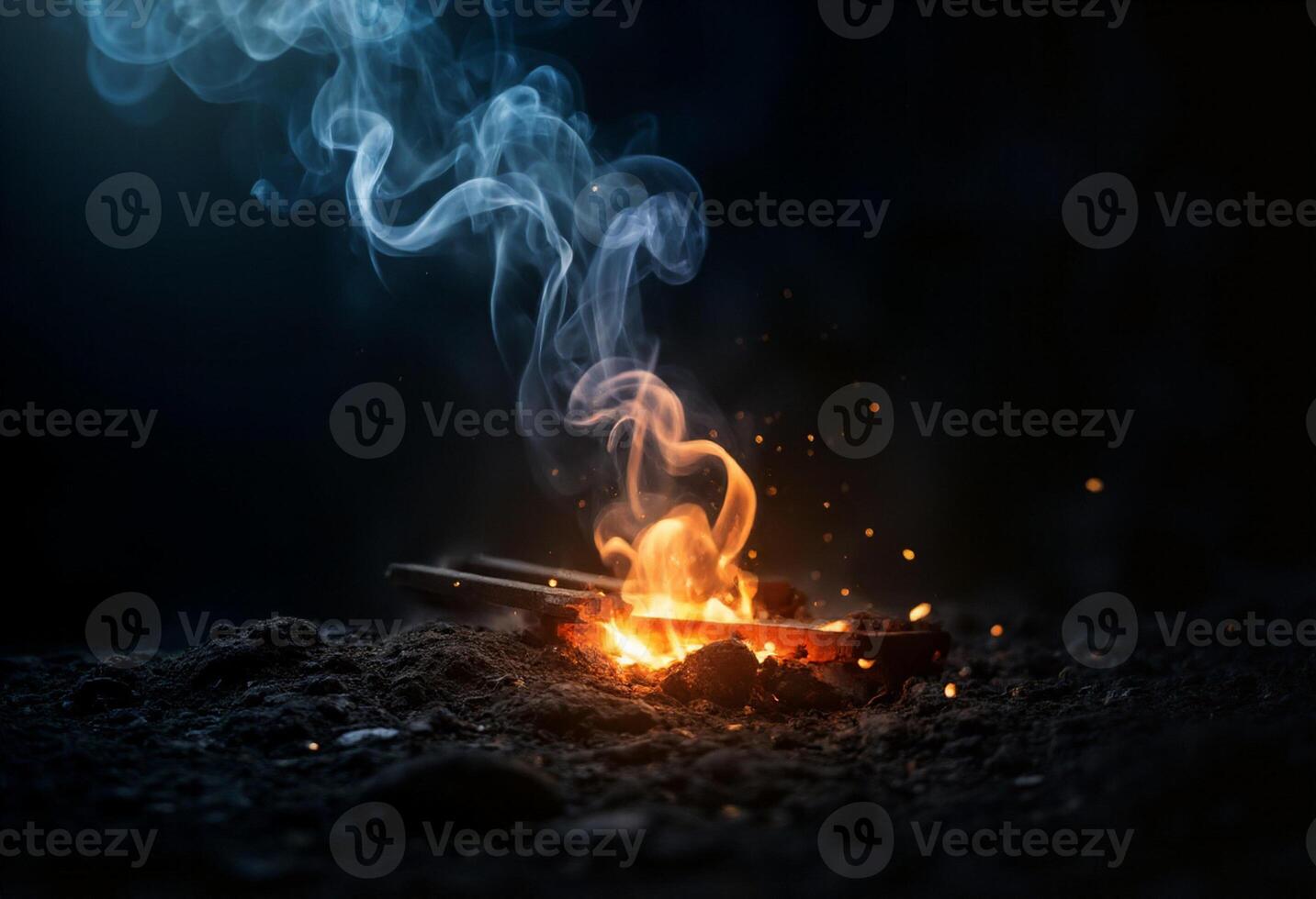 A burning match on a black background photo
