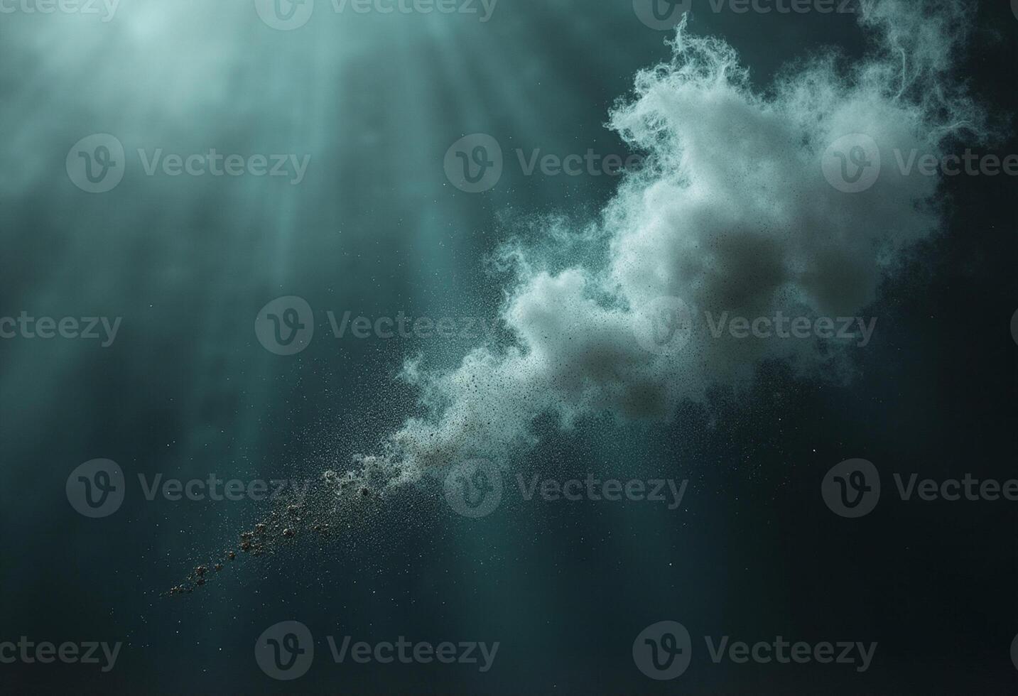 A cloud is floating in the ocean with rays of light coming from it photo