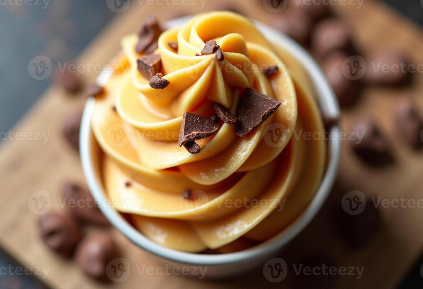A bowl of orange ice cream with chocolate chips photo