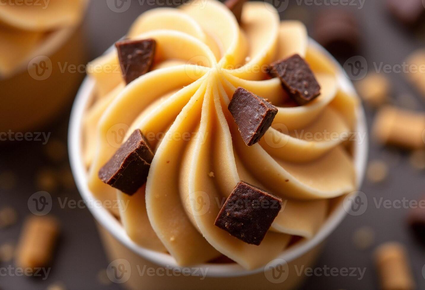 A cupcake with chocolate chips and peanut butter frosting photo