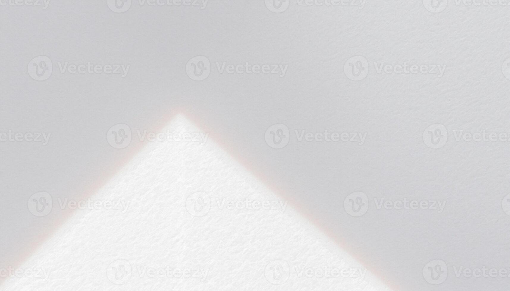 A white triangle with a light shining on it photo