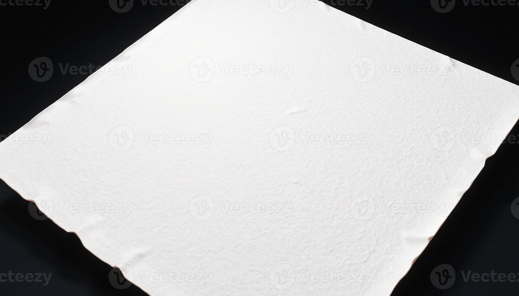 A white sheet of paper on a black surface photo