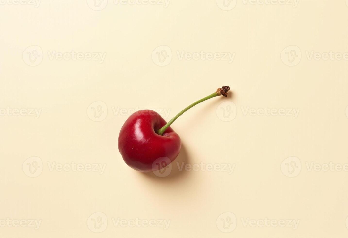 A single cherry on a light beige background photo